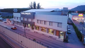 A hotel named 'Hotel Santa Fe' with a modern design, solar panels on the roof, and a visible restaurant sign. - Hotel Santa Fe (Santa Fe)