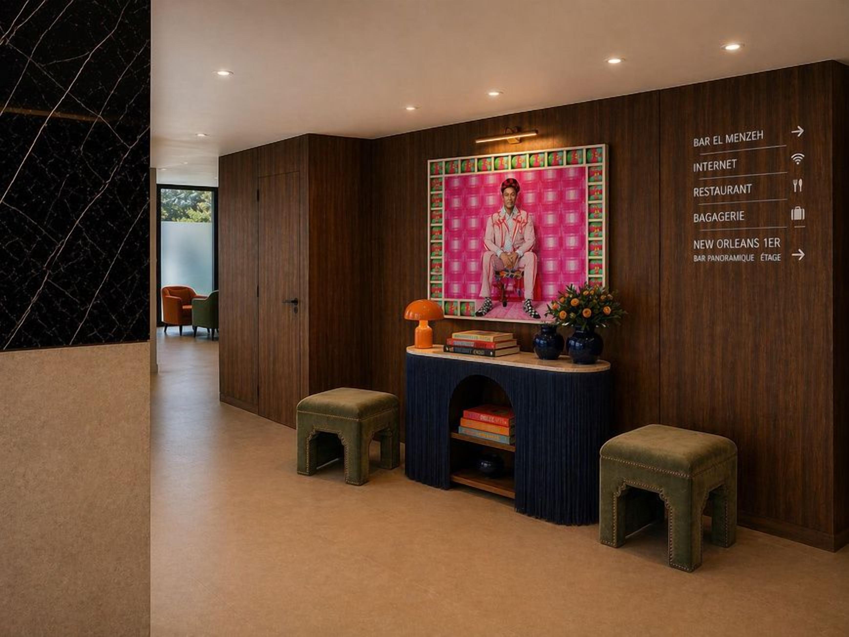 Un hall d’entrée moderne avec un mur en bois, un espace salon et un comptoir d’accueil.