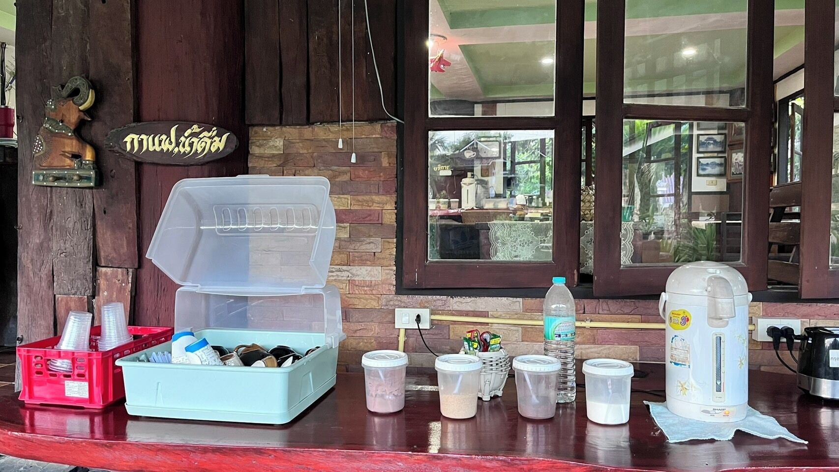A bar area with a coffee machine, a water dispenser, and various containers on the counter.
