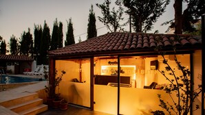 A glass-enclosed reception area with a pool in the background. -  Rolli Butik Hotel (Anamur)