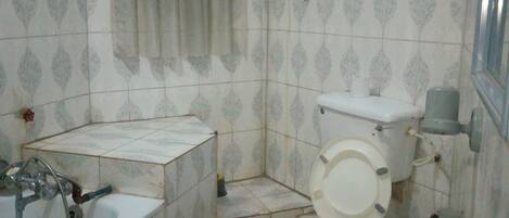 A small bathroom with a sink, toilet, and bathtub.