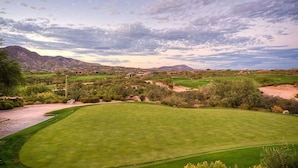 A golf course with a well-maintained green, a clear sky, and distant mountains. - Family Home with Pool, Hot Tub & BBQ near Kierland (Scottsdale)
