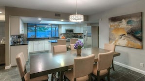 A modern kitchen with a dining area. - Family Home with Pool, Hot Tub & BBQ near Kierland (Scottsdale)