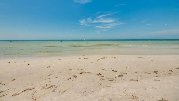 A beach with clear water and a sandy shore. - 231 Pearl Island Cottage Retreat w Private Pool (Fort Myers Beach)