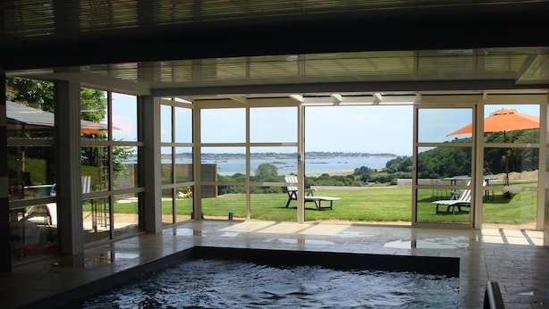 Une piscine avec vue sur une plage et l’océan.