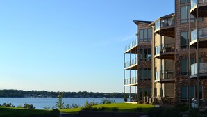 A multi-story building with balconies overlooking a body of water.