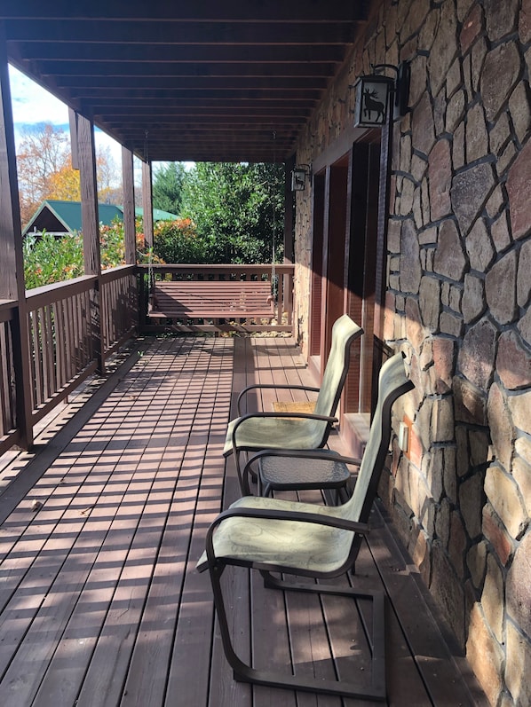 Relax in a serene garden view with lounge chairs and a wooden bench.