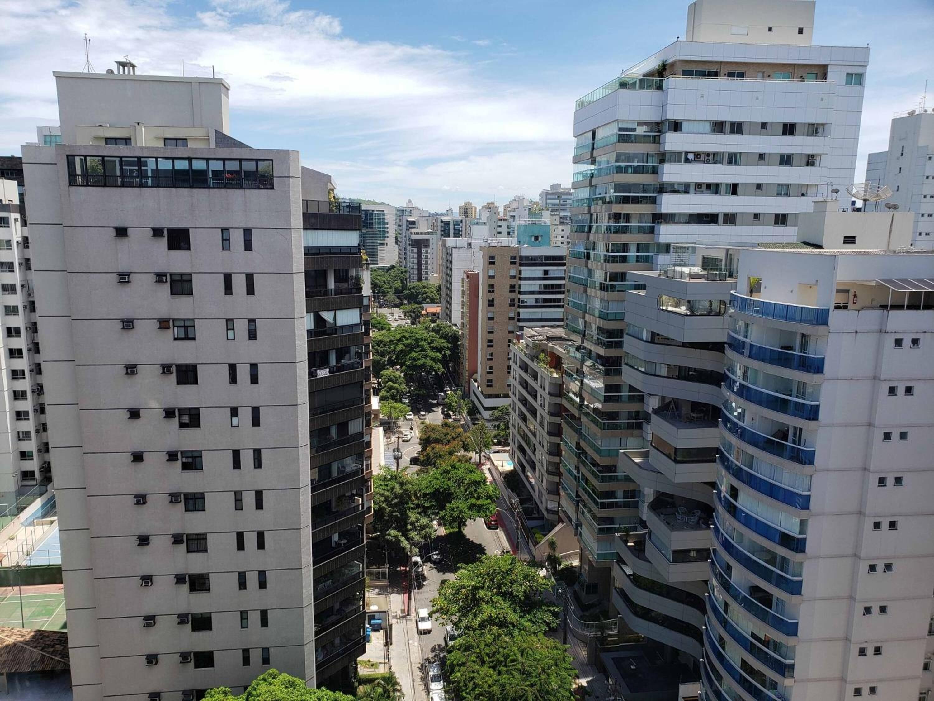 A high-rise building with multiple floors, large windows, and a modern architectural design.