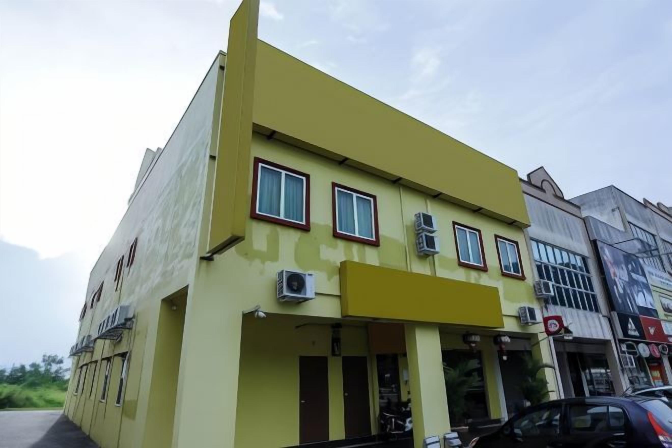 Un immeuble de deux étages, doté d’un toit plat et d’une façade jaune.