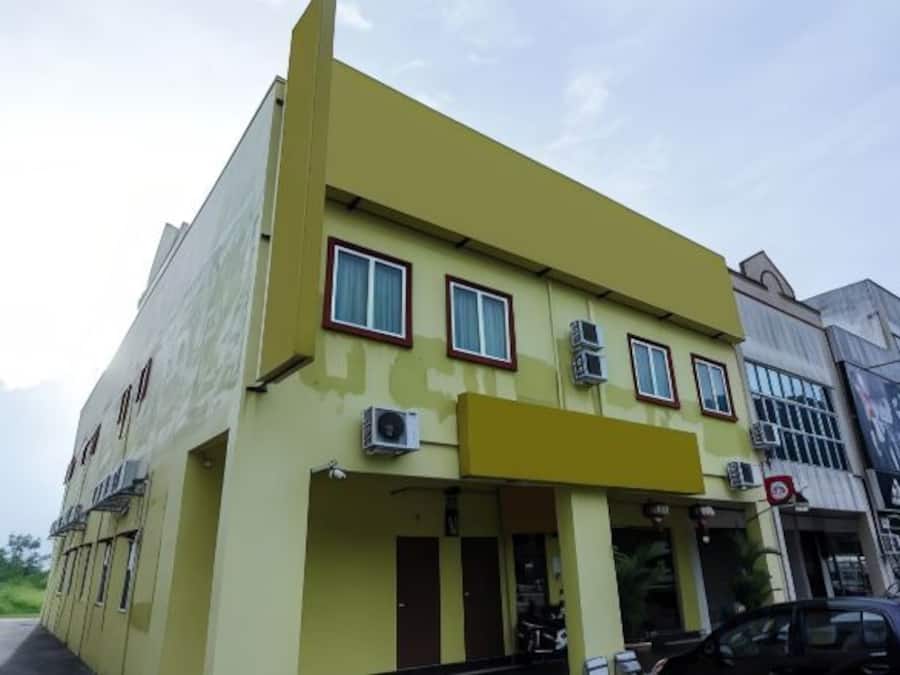 A two-story building with a flat roof and a yellow facade.