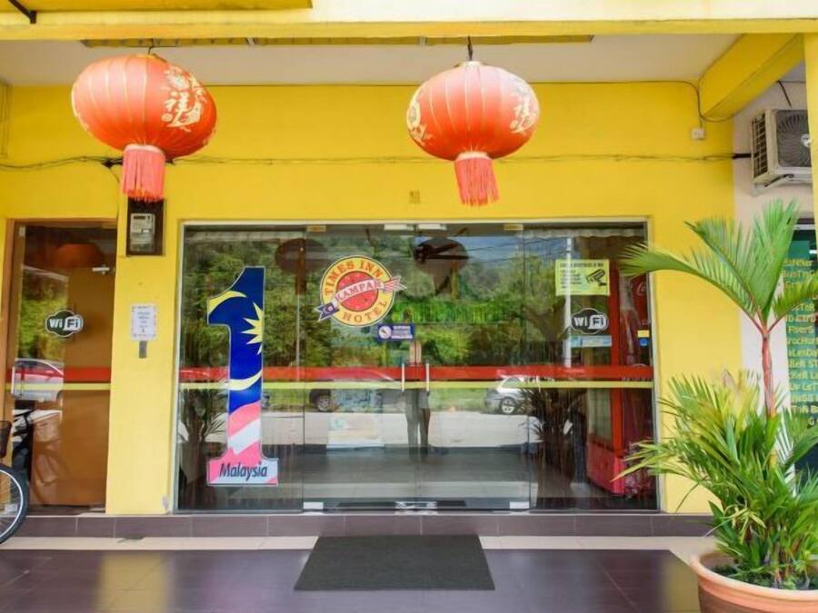 A building entrance with a glass door, a sign with the number 1, and red lanterns.