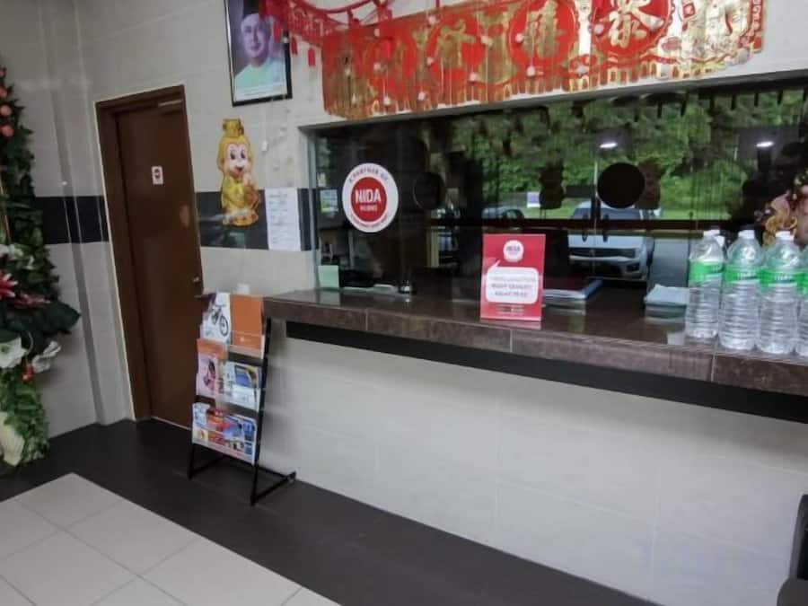 A reception area with a counter, a door, and a poster.