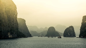 A coastal scene with large rock formations and calm water. - Hoang Giang Hotel (Hai Phong)