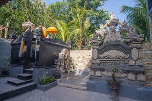 A temple complex with stone structures, steps, and potted plants. - Vivaldi at Jimbaran (Jimbaran)
