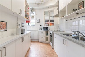 Fridge, microwave, cleaning supplies, paper towels