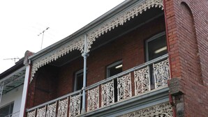 A building with ornate white balcony railings and a brick facade. - Landing Pads Brunswick - Hostel (Brunswick)