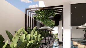 A modern outdoor area with a pool, lounge chairs, and a pergola with greenery. - Floral Hotel Chaweng Koh Samui (Koh Samui)