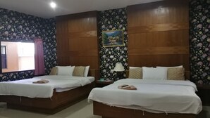 A hotel room with two beds, wooden headboards, floral wallpaper, a painting, and a window with curtains. - Reurn Thai Resort Ratchaburi (Damnoen Saduak)