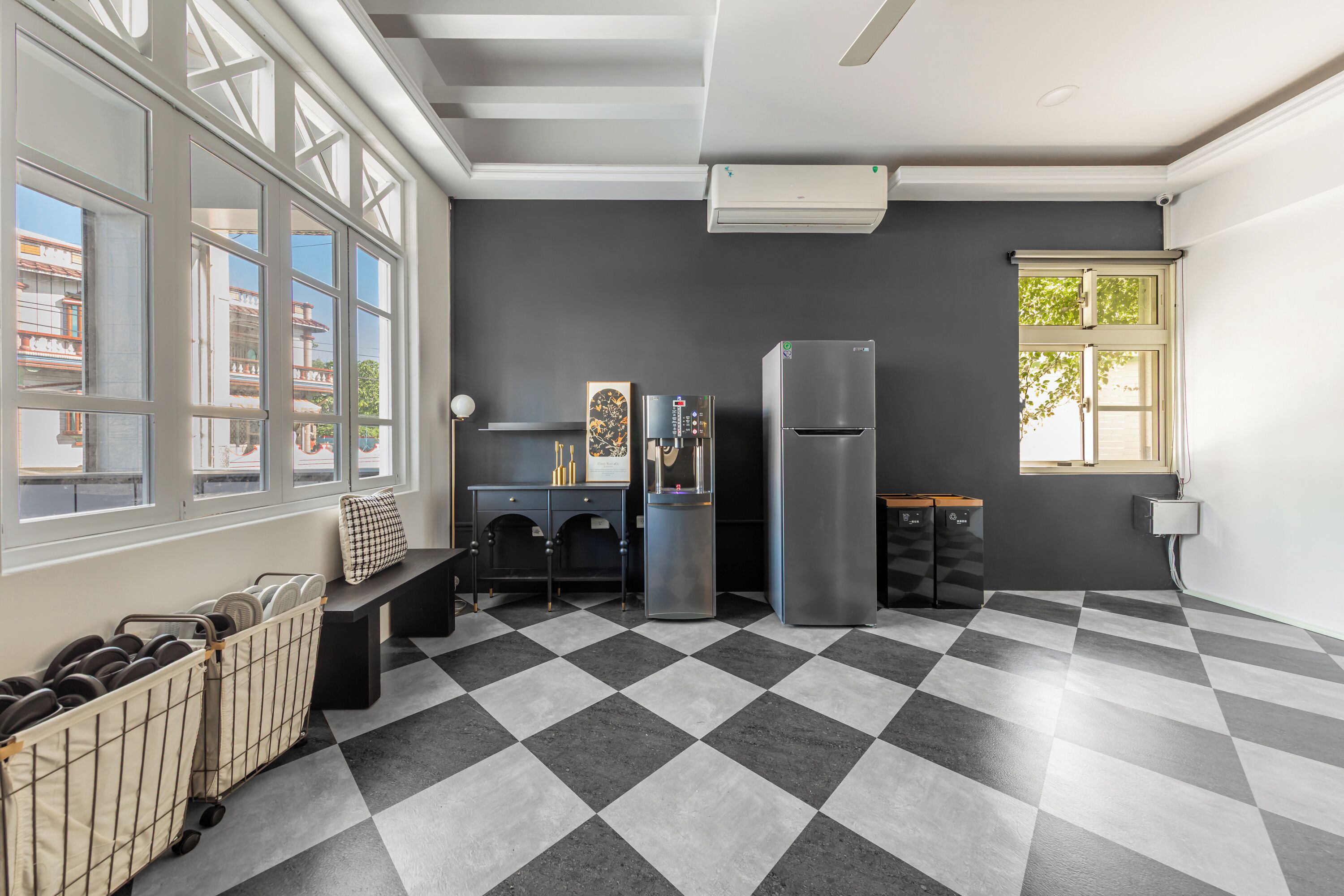 A modern kitchen with a checkered floor, a refrigerator, a microwave, and a sink.