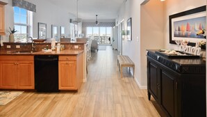 A spacious kitchen with wooden cabinets, a central island, and a dining area with a bench.