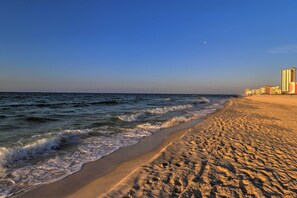 A beach with a clear sky and ocean waves. - 1 Mi to Beach Access: Spacious Orange Beach Duplex (Orange Beach)