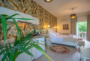 A bedroom with a bed, bedside table, lamp, and a view of the outdoors. - Villa Daizy (Zakynthos)
