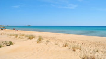On the beach, sun-loungers
