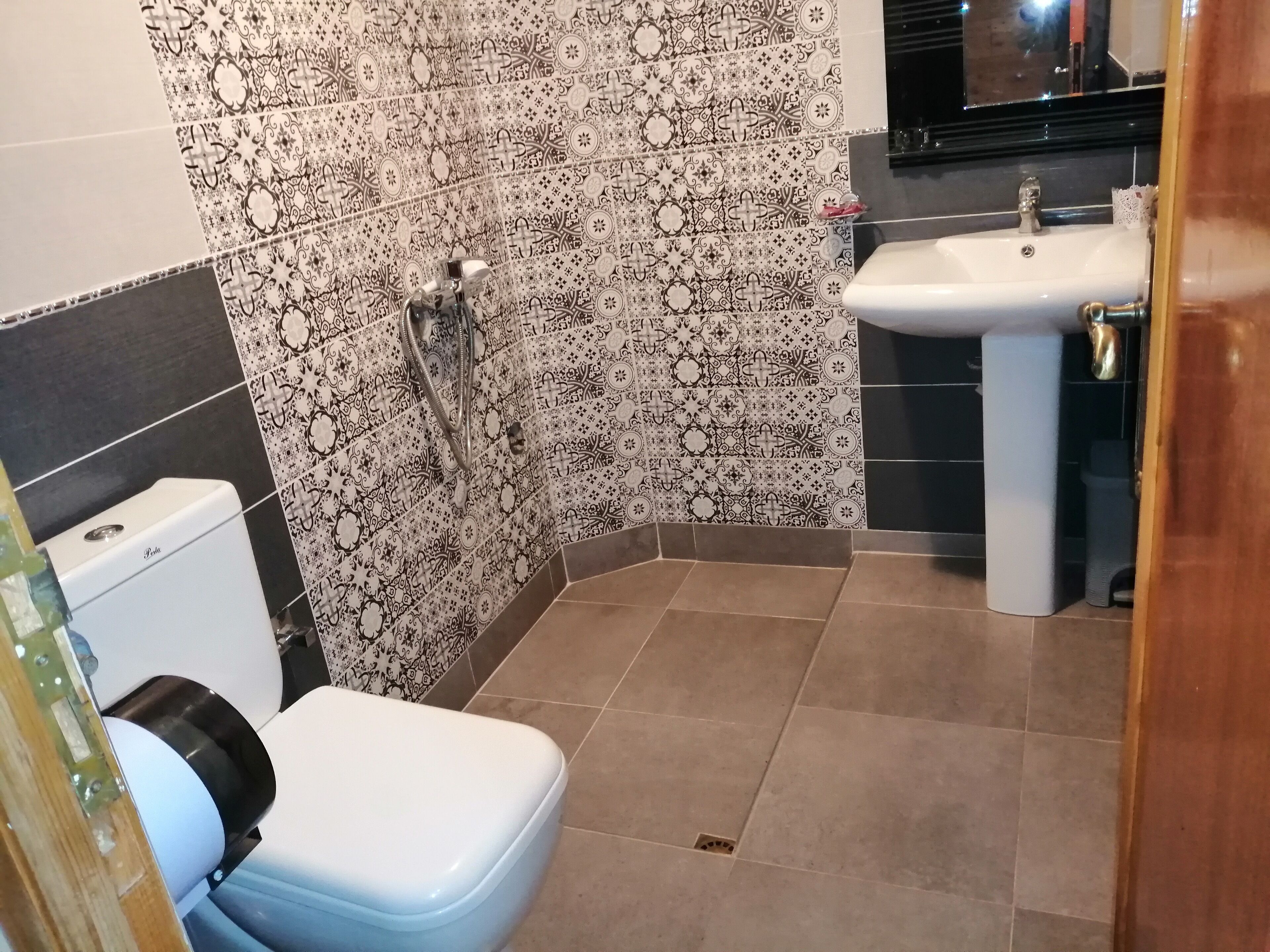 A bathroom with a toilet, a sink, and a shower.