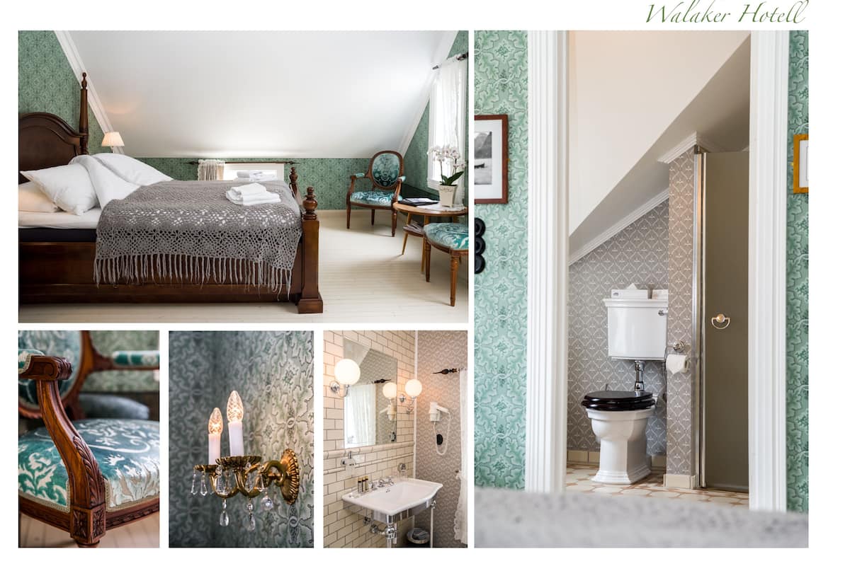 A hotel room with a bed, a chair, a vanity, and a bathroom.