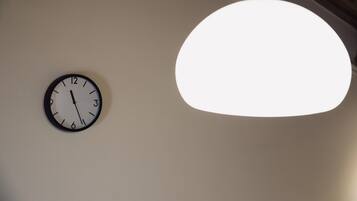 A wall clock and a hanging light fixture.