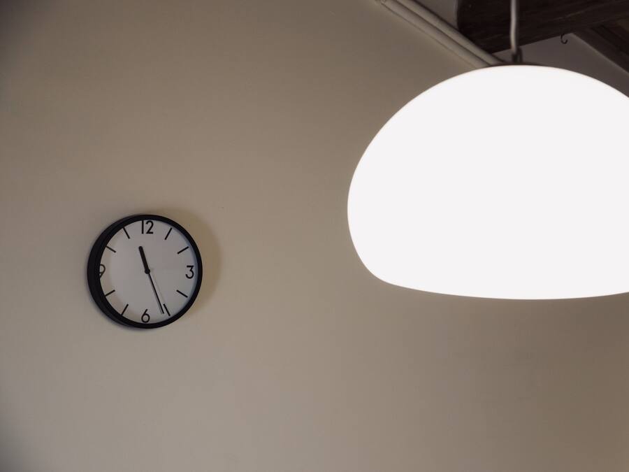 A wall clock and a hanging light fixture.