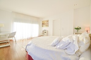 Ein Schlafzimmer mit einem großen Bett, einem Schreibtisch und einem Stuhl.