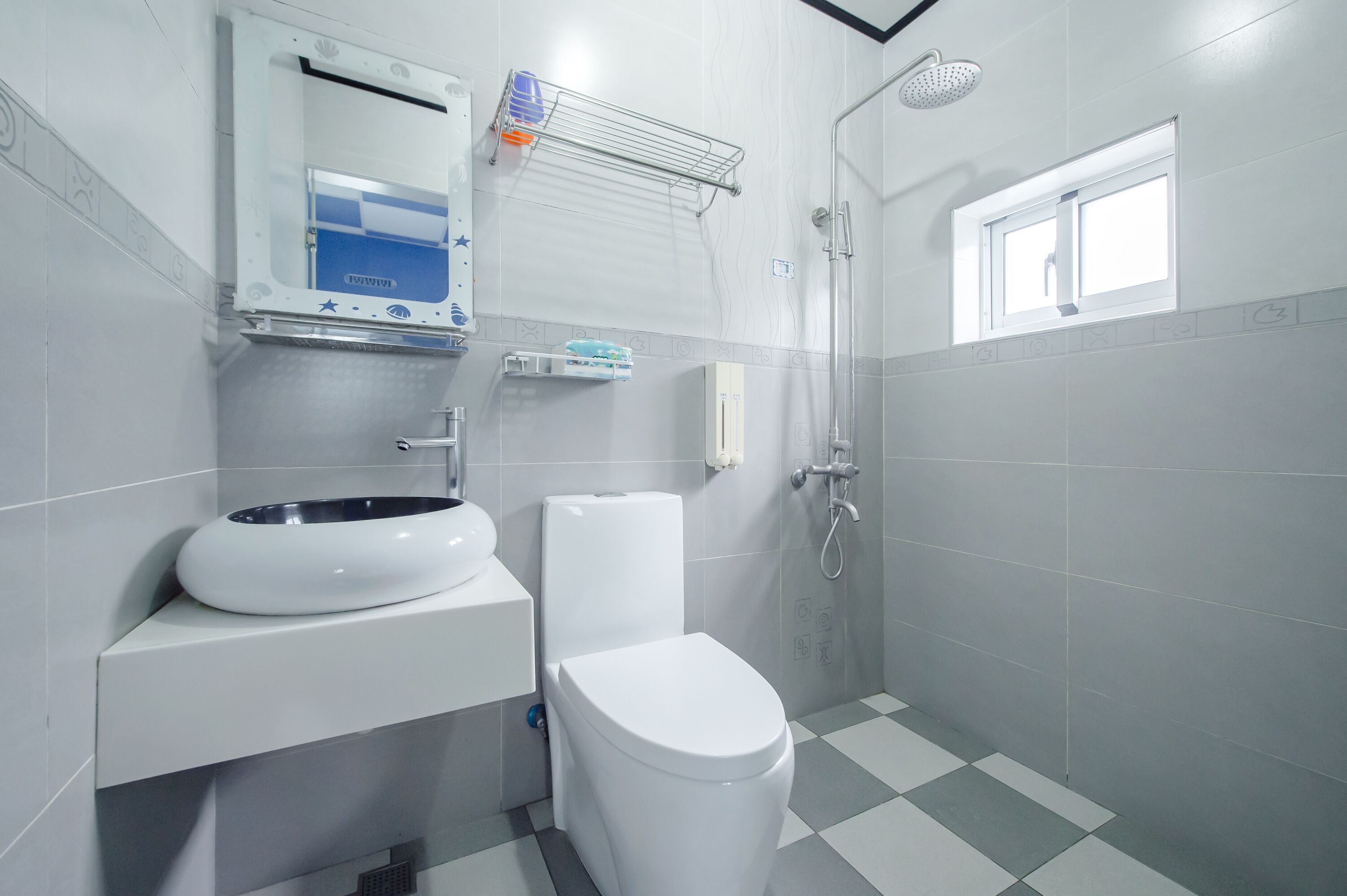 A modern bathroom with a toilet, sink, and shower.