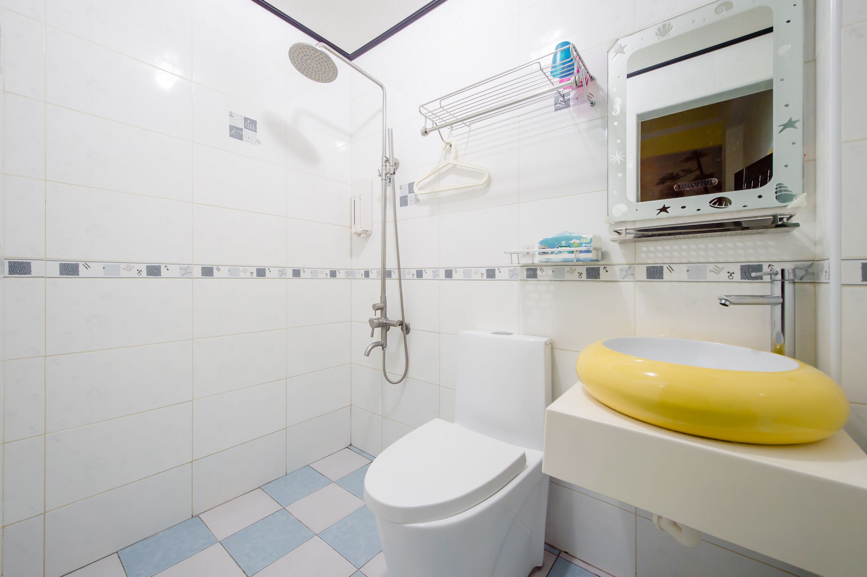 A bathroom with a toilet, sink, and shower.