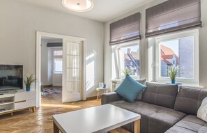 Apartamento, 3 quartos | Sala de estar | TV de tela plana