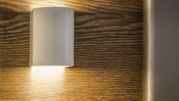 A wall-mounted light fixture on a wooden surface.