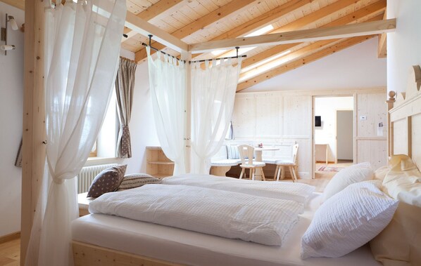 Cozy retreat with a large bed, bedside tables, and a seating area.