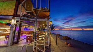 A seaside restaurant with a spiral staircase leading to an outdoor seating area, overlooking the ocean. - 2 Bedrooms Villa Aperol (Koh Samui)