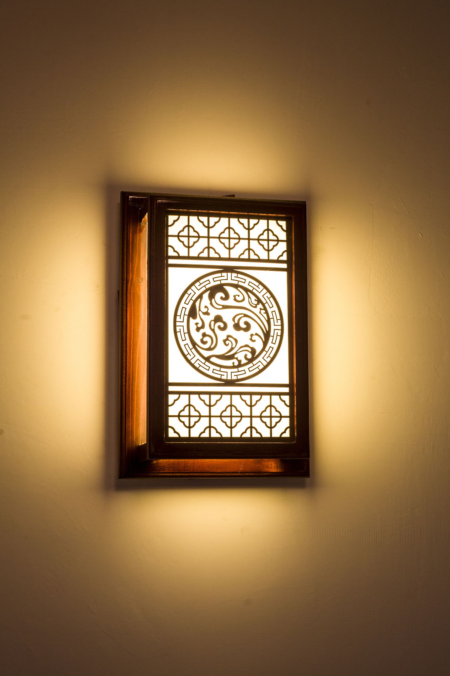 A wall-mounted light fixture with a geometric design.