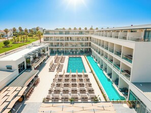 A hotel with a large indoor swimming pool, multiple balconies, and a rooftop terrace. - Victoria Princess Hotel (Manavgat)