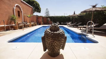 Outdoor pool, open 10:00 AM to 10:00 PM, pool loungers