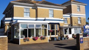 A two-story building with a ground-floor shop and upper residential units. - Sandhill (Sandown)