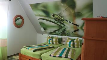 Cozy retreat with a unique dragonfly mural and two comfortable beds.
