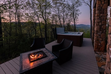 Back deck with incredible mountain views. Fire table with swivel/rocking chairs, along with hot tub (railing has been added as of May 2018).