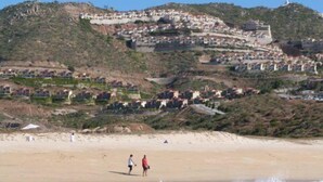 A coastal town with buildings on a hillside, a sandy beach, and the ocean. -  Montecristo Luxury Villa#11-Christmas/New Years-Highest Pt/Best View-12/16-1/17 (Quivira)