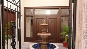 A courtyard with a three-tiered fountain, a gated entrance, and a potted plant. -  Montecristo Luxury Villa#11-Christmas/New Years-Highest Pt/Best View-12/16-1/17 (Quivira)