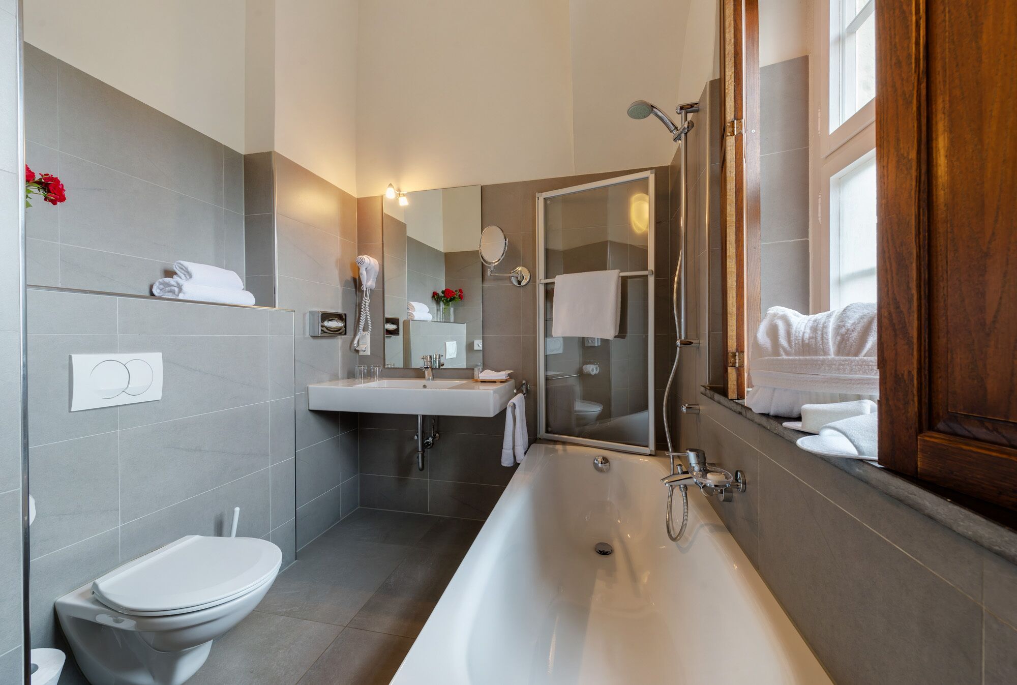 junior suite | bathroom | bathtub, free toiletries, hair dryer, bathrobes