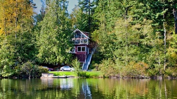 A house with a two-story structure, a staircase leading up to it, and a dock with a car. - Emerald Lake Chalet - SUMMERTIME! (Bellingham)