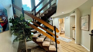 A wooden staircase with stone steps leading to a second floor. - Monkey Island Waterfront with Dock and boat ramp right next to it. (Afton)