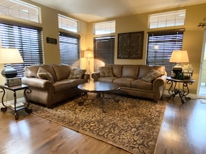 Relax in this stylish living room with two sofas, a coffee table, and area rug.